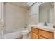 Well-lit bathroom features a skylight, a shower-tub combination, and a sink with tile backsplash at 2904 Channel Bay Dr, Las Vegas, NV 89128
