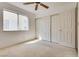 Cozy bedroom featuring neutral carpeting, a ceiling fan and a closet, with natural light at 2904 Channel Bay Dr, Las Vegas, NV 89128