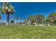 Open grassy park with mature trees and picnic tables by the lake, ideal for outdoor recreation at 2904 Channel Bay Dr, Las Vegas, NV 89128
