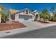 Inviting single-Gathering home with a two-car garage, desert landscaping, and mature tree at 2904 Channel Bay Dr, Las Vegas, NV 89128