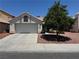 Inviting single-Gathering house with a two-car garage, tile roof and desert landscaping offers timeless curb appeal at 2904 Channel Bay Dr, Las Vegas, NV 89128