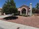 Well-maintained home with a tile roof, decorative chimney, manicured bushes and desert landscaping at 2904 Channel Bay Dr, Las Vegas, NV 89128