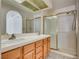 Main bathroom featuring a large dual vanity area and walk-in shower enclosed with glass sliding doors at 2904 Channel Bay Dr, Las Vegas, NV 89128
