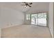 Spacious main bedroom with vaulted ceilings, a ceiling fan, and access to the backyard patio area at 2904 Channel Bay Dr, Las Vegas, NV 89128