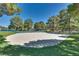 Community sand volleyball court and basketball court surrounded by trees and lush grass at 2904 Channel Bay Dr, Las Vegas, NV 89128