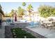 An inviting backyard with a refreshing pool, complemented by a lounge area and lush landscaping at 3436 N Tenaya Way, Las Vegas, NV 89129