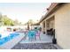 A beautiful patio and pool area with ample seating for entertaining, set against a desert landscape at 3436 N Tenaya Way, Las Vegas, NV 89129