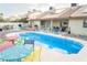 Backyard featuring a sparkling pool, patio with seating, and well-maintained landscaping for outdoor enjoyment at 3436 N Tenaya Way, Las Vegas, NV 89129