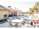 Backyard featuring a pool, a covered patio area, desert landscaping, and solar panels on the roof at 3436 N Tenaya Way, Las Vegas, NV 89129