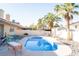 Backyard with a pristine pool, a lounge area and desert landscaping, and solar panels on the roof at 3436 N Tenaya Way, Las Vegas, NV 89129