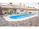 Backyard featuring a pool, patio with seating, and well-maintained landscaping for outdoor enjoyment at 3436 N Tenaya Way, Las Vegas, NV 89129