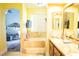 Bathroom with tub set in marble, flat screen television, and view to the main bedroom at 3436 N Tenaya Way, Las Vegas, NV 89129
