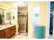 Bathroom with a vanity with double sinks, walk-in shower, toilet, and blue storage chest at 3436 N Tenaya Way, Las Vegas, NV 89129