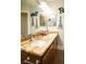 Bathroom featuring granite counters, double sinks and Paris themed decor at 3436 N Tenaya Way, Las Vegas, NV 89129