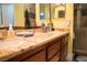 Bathroom vanity features granite counters, wood cabinets, a sink, and an outlet at 3436 N Tenaya Way, Las Vegas, NV 89129
