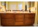 Bathroom vanity features granite counters, wood cabinets, double sinks, and a large mirror at 3436 N Tenaya Way, Las Vegas, NV 89129