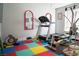 Home gym featuring a treadmill, rowing machine, and weight training equipment on colorful flooring at 3436 N Tenaya Way, Las Vegas, NV 89129