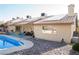 The backyard features a pristine pool, patio, desert landscaping, and solar panels on the roof at 3436 N Tenaya Way, Las Vegas, NV 89129