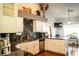 Spacious kitchen showcasing granite countertops, white cabinets, stainless steel appliances, and open view to a living room at 3436 N Tenaya Way, Las Vegas, NV 89129