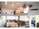 Bright eat-in kitchen featuring white cabinets, granite countertops and a ceiling fan at 3436 N Tenaya Way, Las Vegas, NV 89129