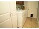 Laundry room features modern appliances, storage space, and a pet door for convenience at 3436 N Tenaya Way, Las Vegas, NV 89129