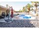 A private backyard oasis with a sparkling pool, lounge area, and desert landscaping at 3436 N Tenaya Way, Las Vegas, NV 89129