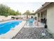 Backyard pool area, landscaping and outdoor furniture including BBQ make the space ideal for entertaining at 3436 N Tenaya Way, Las Vegas, NV 89129