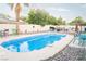 A rectangular pool area with outdoor furniture and a grill, perfect for backyard barbeques and entertaining guests at 3436 N Tenaya Way, Las Vegas, NV 89129