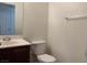 Powder room features wood cabinetry, white toilet, and decorative mirror at 3728 Prairie Orchid Ave, North Las Vegas, NV 89081