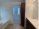 Bathroom features a double sink vanity, tile flooring, and large soaking tub at 3728 Prairie Orchid Ave, North Las Vegas, NV 89081