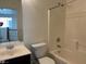 Bright bathroom featuring a bathtub and shower combo, sink with wood cabinet, and a toilet at 3728 Prairie Orchid Ave, North Las Vegas, NV 89081