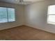 Bedroom with two windows offering ample natural light, plush carpeting and a ceiling fan at 3728 Prairie Orchid Ave, North Las Vegas, NV 89081