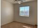 Bedroom with neutral carpet, white walls, a window for natural light, and ceiling fan at 3728 Prairie Orchid Ave, North Las Vegas, NV 89081