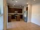Spacious kitchen features stainless steel appliances, dark cabinetry, and an island at 3728 Prairie Orchid Ave, North Las Vegas, NV 89081