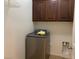 Laundry room features new washer and dryer and storage cabinets at 3728 Prairie Orchid Ave, North Las Vegas, NV 89081