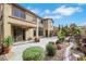 Expansive backyard with lush greenery, stone accents, and covered patio at 3728 White Lion Ln, North Las Vegas, NV 89084