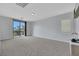Spacious carpeted bedroom with access to balcony for natural light at 3728 White Lion Ln, North Las Vegas, NV 89084