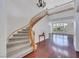 Stunning entryway with a curved staircase, wood floors, and a decorative chandelier at 3728 White Lion Ln, North Las Vegas, NV 89084