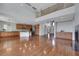 Open floor plan with wood floors, combining the living area, kitchen, and a staircase to the second floor at 3728 White Lion Ln, North Las Vegas, NV 89084