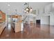 Open-concept living space with hardwood floors, fireplace, and large kitchen island with granite countertops at 3728 White Lion Ln, North Las Vegas, NV 89084