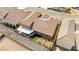 Aerial shot of the home's backyard featuring desert landscaping, a covered patio, and a privacy fence at 3811 Queen Elizabeth Ct, Laughlin, NV 89029