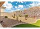 Gravel backyard with decorative stone landscaping and artificial grass at 3811 Queen Elizabeth Ct, Laughlin, NV 89029