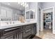 Spacious bathroom with double vanity, large mirrors, and a walk-in closet at 3811 Queen Elizabeth Ct, Laughlin, NV 89029