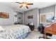 Bedroom with neutral colors, ceiling fan, and a desk area at 3811 Queen Elizabeth Ct, Laughlin, NV 89029