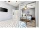 Comfortable bedroom featuring mirrored closet doors, ceiling fan, and a ceiling light fixture at 3811 Queen Elizabeth Ct, Laughlin, NV 89029