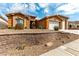 Charming single-story home showcasing xeriscaping, multi-car garage, and a beautifully contrasting stucco exterior at 3811 Queen Elizabeth Ct, Laughlin, NV 89029