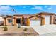 Well-maintained home with a three car garage and desert landscaping at 3811 Queen Elizabeth Ct, Laughlin, NV 89029