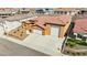 Stunning exterior of a tan home with three-car garage, landscaped yard, and tile roof in a quiet neighborhood at 3811 Queen Elizabeth Ct, Laughlin, NV 89029