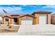 Well-maintained home with a three car garage and desert landscaping at 3811 Queen Elizabeth Ct, Laughlin, NV 89029