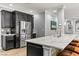 Open-concept kitchen with marble countertops, stainless steel fridge, and dark wood cabinets at 3811 Queen Elizabeth Ct, Laughlin, NV 89029